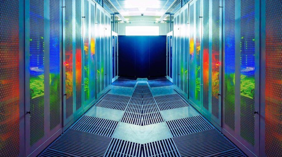 A brightly lit, futuristic data center with rows of server racks reflecting colorful lights-business continuity plan