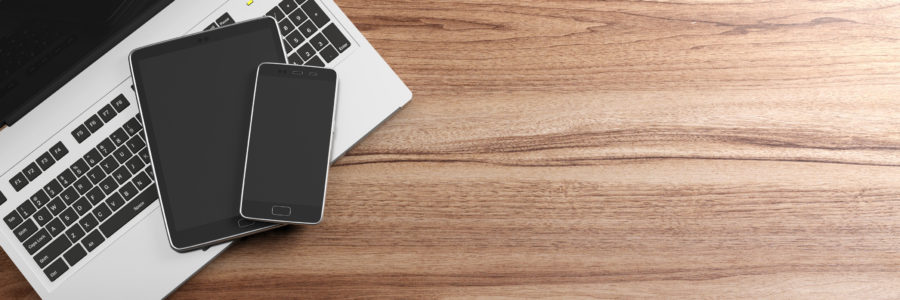 Laptop, tablet, and smartphone on a wooden desk-byod policy