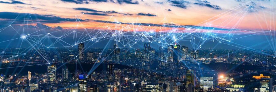 A futuristic city skyline at dusk with a digital network overlay-internet of things​