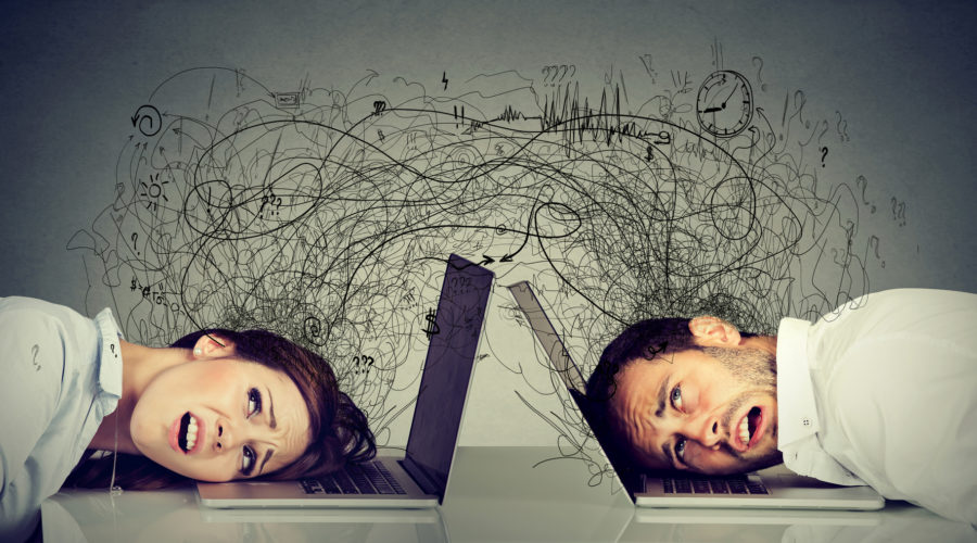 Frustrated business professionals with heads on laptops-business Intelligence software