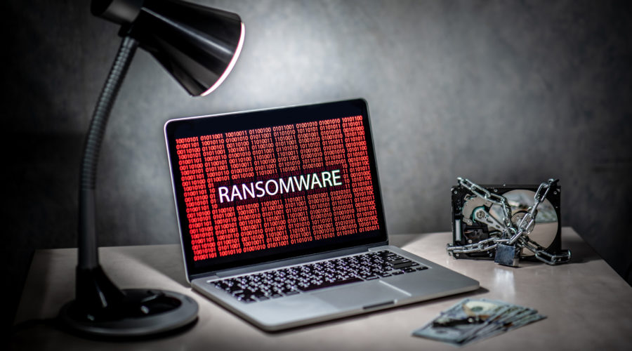 Hard disk file locked by chain and padlock with laptop computer - ransomware prevention​