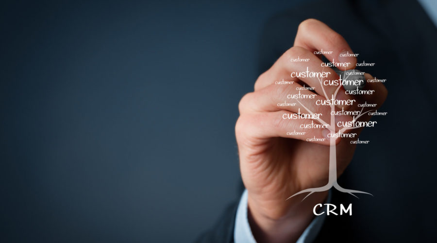 hand holding a digital pen on transparent screen - crm overview​