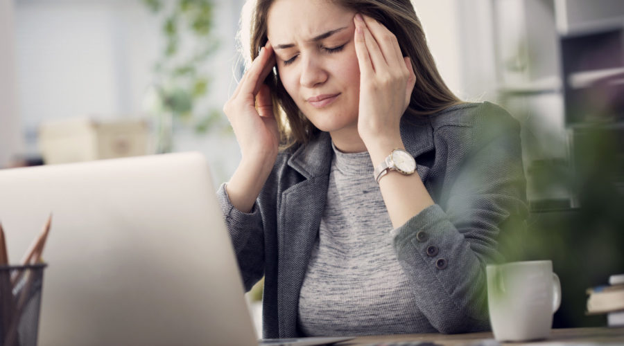 Person facing laptop - how to implement new technology in the workplace​