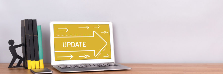A laptop on a wooden desk displaying an Update-software update
