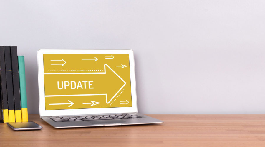 A laptop on a wooden desk displaying an Update-software update
